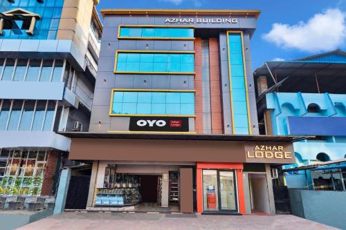 a building with an akara lodge sign on it at Hotel O Azhar lodge in Calicut