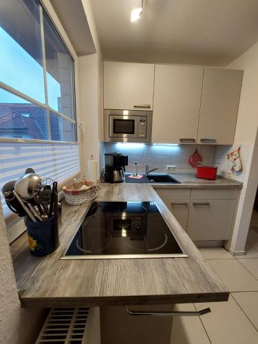 a kitchen with a sink and a stove in it at Birkenquartier in Zingst