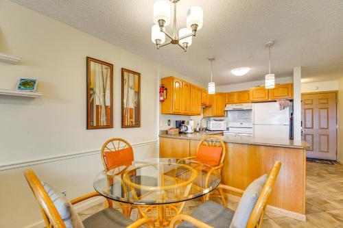 a dining room and kitchen with a glass table and chairs at Walk to Nawiliwili Harbor Condo with Saltwater Pool in Lihue