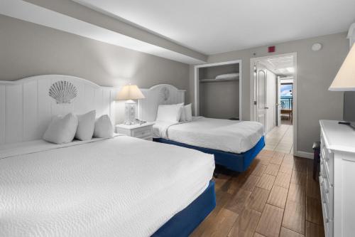 a hotel room with two beds and a bathroom at Monterey Bay Suites in Myrtle Beach