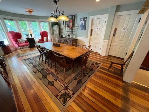 a dining room and living room with a table and chairs at Jamaicahaus in Jamaica
