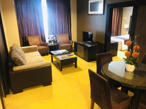 a living room with a couch and a table at Hotel Felda Residence Kuala Terengganu in Kuala Terengganu
