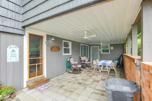 a patio with a table and chairs on it at 1 Mi to Burr Oak Lake Home with Deck and Patio! in Corning