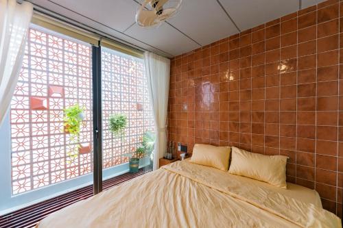a bedroom with a bed and a large window at Local Charm Homestay in Thôn Trường Giang