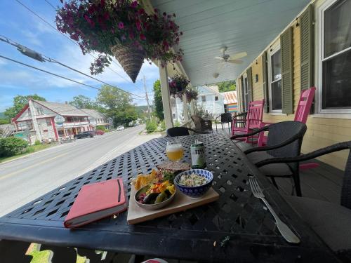 a table with a bowl of fruit and a drink at Jamaicahaus in Jamaica