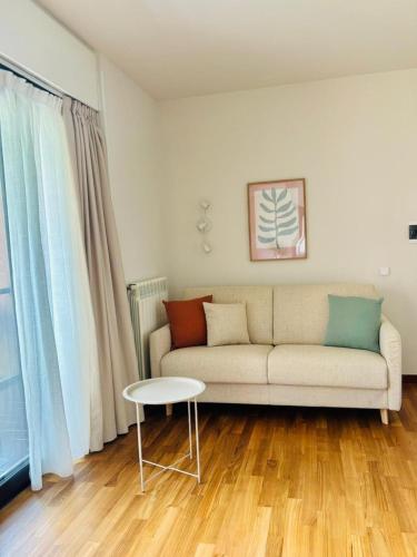 a living room with a couch and a table at LuMI Apartment in Basiglio