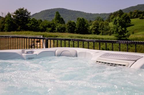 a jacuzzi tub in a backyard with a fence at Family Resort Plitvice Lakes in Rastovača