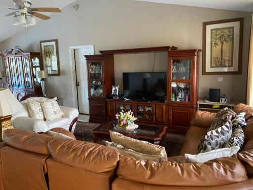 a living room with a couch and a television at Peaceful stay at Grandmas house in Kissimmee