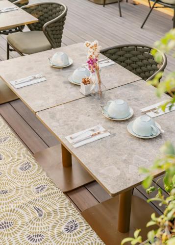 a wooden table with plates and napkins on it at Vincci Mae in Barcelona