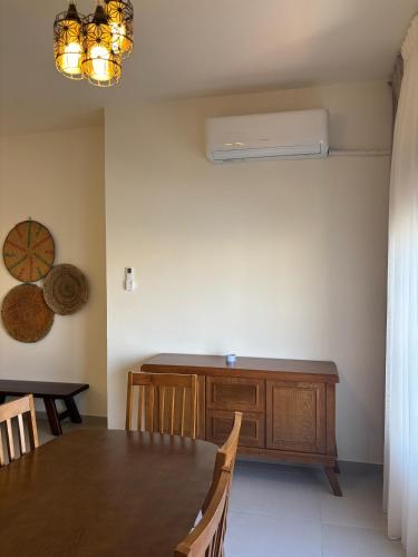 a dining room with a wooden table and a desk at Modern 2BR in Trendy Jabal AlWebdeh with View in Amman