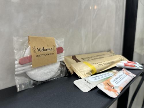 a table with two bags of towels and toothbrushes at Jo's Studios in Mirina
