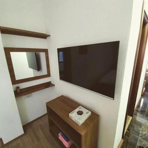 a living room with a large flat screen tv on the wall at Konak Hilltop Lodge & Villa in Kruševo