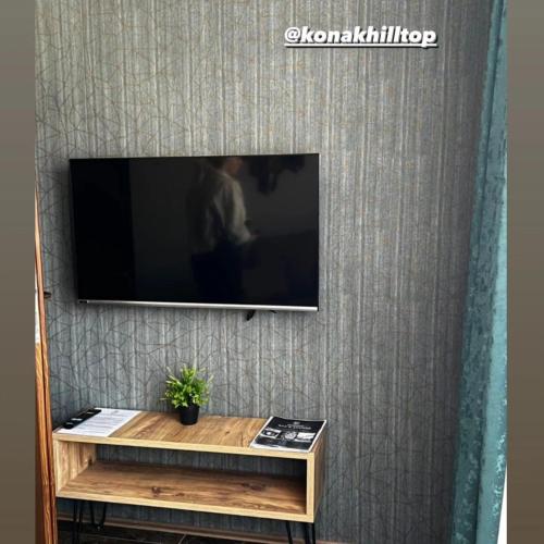 a flat screen tv hanging on a wall at Konak Hilltop Lodge & Villa in Kruševo