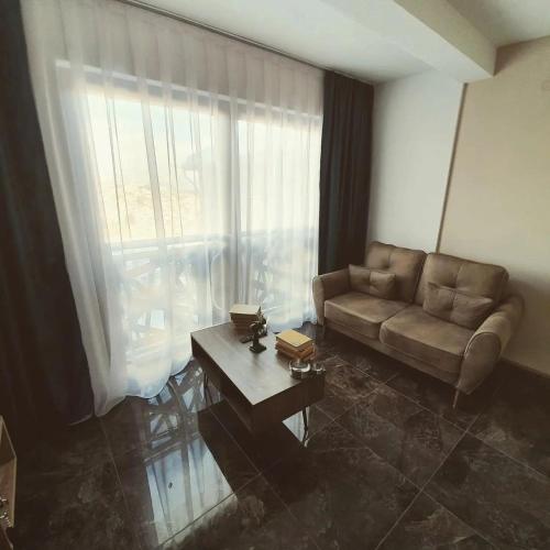 a living room with a couch and a coffee table at Konak Hilltop Lodge & Villa in Kruševo
