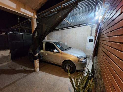 a small car parked inside of a garage at Hospedaje Choya in San Fernando del Valle de Catamarca
