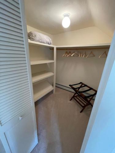 a room with a closet with hangers and a shelf at Jamaicahaus in Jamaica