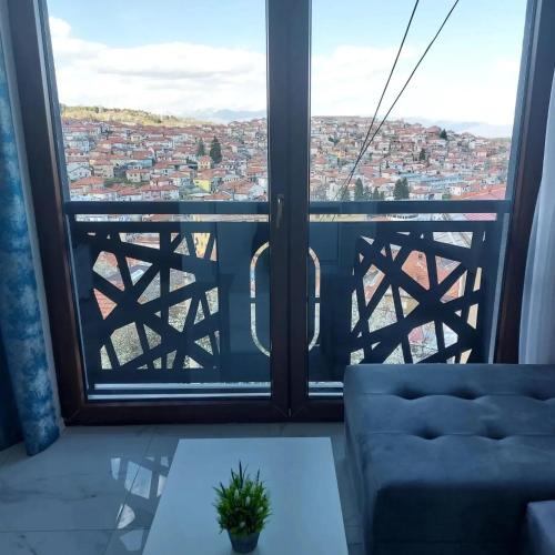a room with a view of a city from a window at Konak Hilltop Lodge & Villa in Kruševo