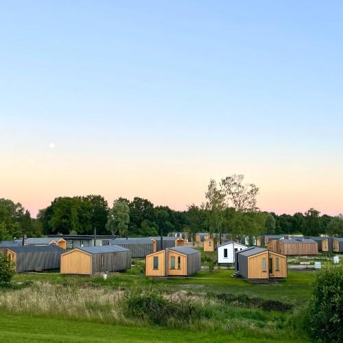 a group of tiny houses in a field at 208-Tiny House an der Elbe mit Blick ins Grüne in Bleckede