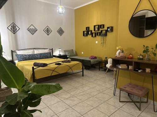 a bedroom with a bed and a living room at Jo's Studios in Mirina