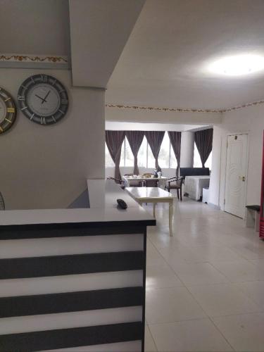 a living room with a clock on the wall at The Royal Kulob in Kŭlob