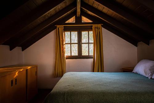 a bedroom with a large bed and a window at Amanecer en las Piedras in Tandil