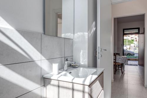 a bathroom with a sink and a mirror at Fossato 35 Flat Pontassieve in Pontassieve