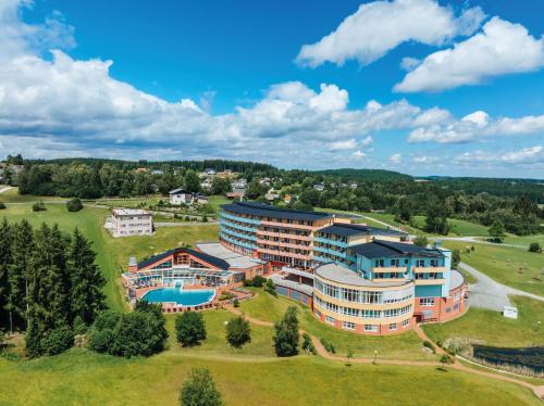 an aerial view of a resort building with a pool at Vivea Hotel Bad Traunstein 
