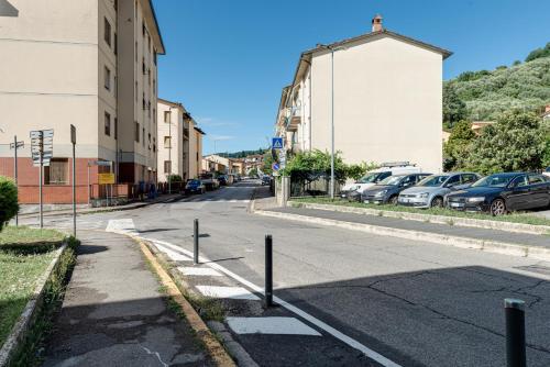 an empty street with cars parked in a parking lot at Fossato 35 Flat Pontassieve in Pontassieve