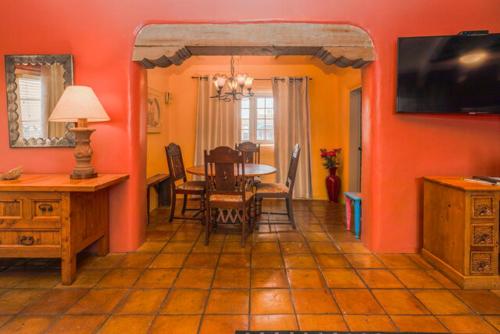 a dining room with a table and chairs in a room at Casa Benavides Inn in Taos