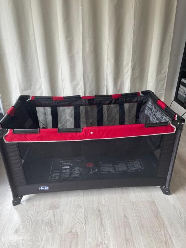 a bed with a red and black bed frame at 7 people - 1 price - Cozy attic apartment in Prešov
