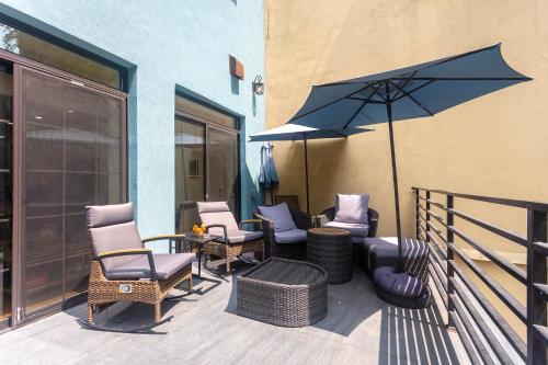 a patio with chairs and an umbrella next to a building at Little manhattan near Time Square in New York