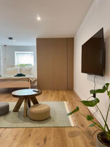 a living room with a table and a couch at Two Tangerines in Milicz