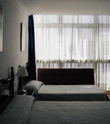 Una cama o camas en una habitación de HOTEL Paquita