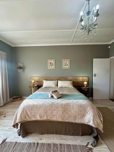 a bedroom with a large bed with a chandelier at Mia Amore in Caledon