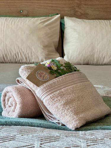a towel on a bed with a book on it at Mia Amore in Caledon