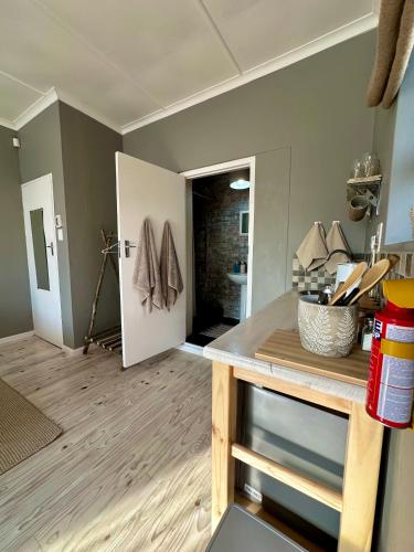a room with a kitchen with a counter and a door at Mia Amore in Caledon