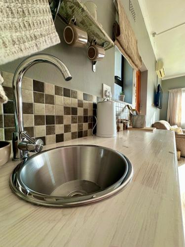 a kitchen counter with a stainless steel sink at Mia Amore in Caledon