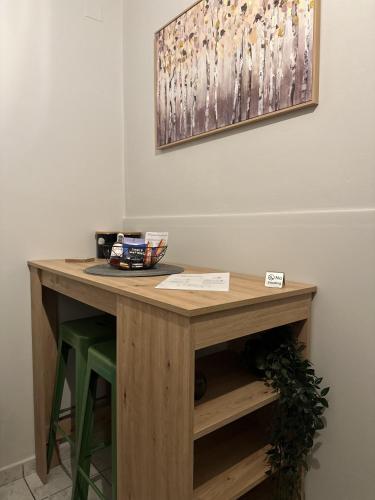 a table in a room with a painting on the wall at Jo's Studios in Mirina
