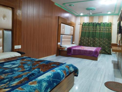 a bedroom with two beds and a mirror at Sehran palace in Srinagar