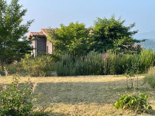 an old house in the middle of a garden at Eco Gîte in Payzac