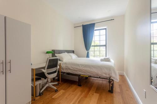 a bedroom with a bed and a desk and a chair at Little manhattan near Time Square in New York