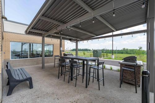 a patio with a table and chairs and a bench at Candlewood Suites - Detroit - Auburn Hills by IHG in Auburn Hills