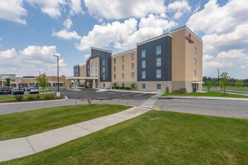 a large building on a street with a green lawn at Candlewood Suites - Detroit - Auburn Hills by IHG in Auburn Hills