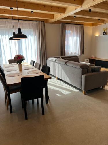 a living room with a table and a couch at Chata Vojtek in Terchová