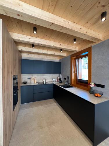 a kitchen with blue cabinets and a counter top at Chata Vojtek in Terchová