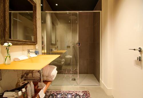 a bathroom with a shower with a sink and a toilet at Foresteria, Winery & Events Destination in Monforte dʼAlba