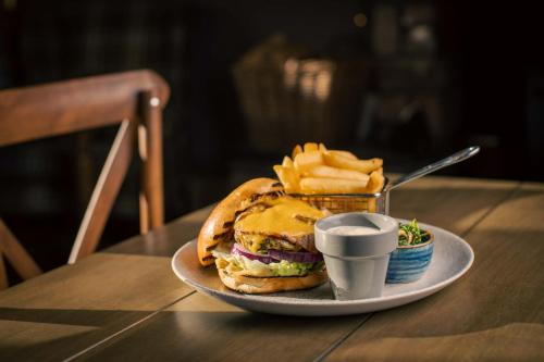 a plate with a sandwich and french fries on a table at The Murray Park Hotel in Crieff