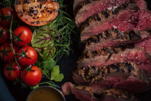 a plate of meat and tomatoes and a bowl of sauce at The Murray Park Hotel in Crieff