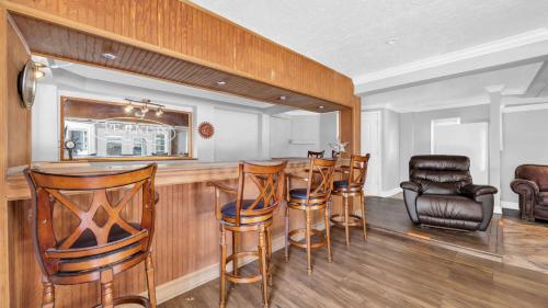 a bar in a home with wooden bar stools at Relaxing Cherry Grove Beach House with Balcony Family Fun in Myrtle Beach