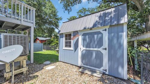 a small blue shed with a door with a flag at Relaxing Cherry Grove Beach House with Balcony Family Fun in Myrtle Beach